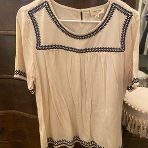 Cream blouse with dark navy blue accent